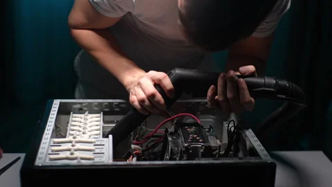 Front view of focused computer master cleaning inside of system unit case with Stock Footage 276424010