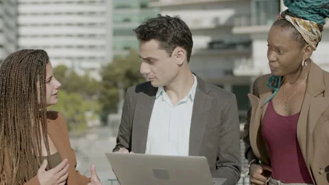 Front view of focused coworkers working together outdoor Stock Footage 167412675