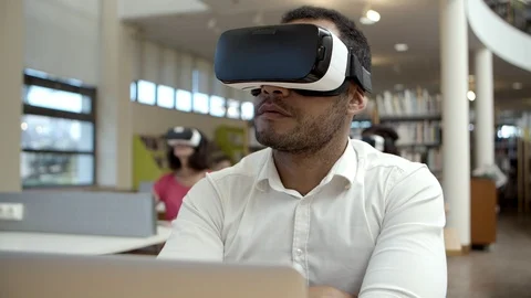 Front view of focused guy with VR headset looking around 動画素材 117308180