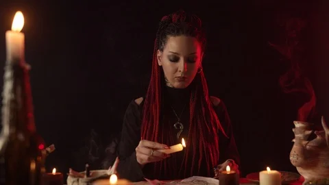 Front view of focused witch dripping wax on pentagram Vídeo Stock 125025595