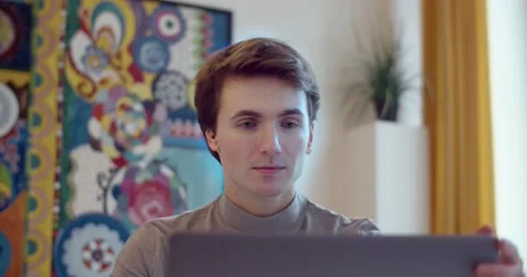 Front view of freelancer relaxing after work on computer indoors slow motion Stock Footage 142003303