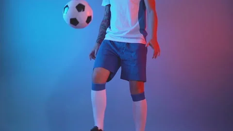 Front view of freestyle soccer or futsal player juggling ball with his legs Stock Footage 141922111