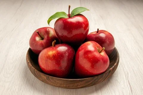 Front view fresh red apples ripe and mellow fruits on white desk fruit colo.. Stock Photos