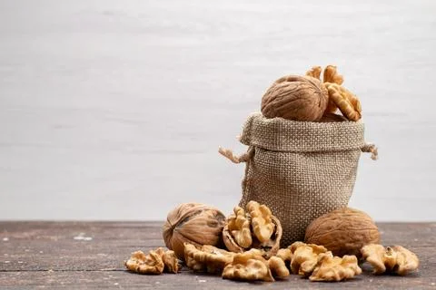 Front view fresh whole walnuts in shells and cleaned up on the light backgr.. Stock Photos