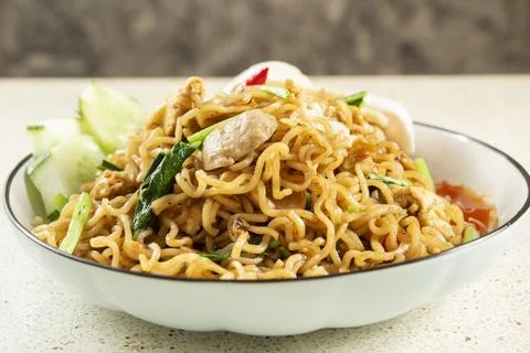 Front view of fried noodles close up with meatball topping, fried egg Stock Photos