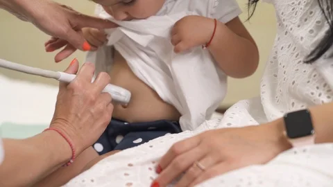 A front view of a friendly sonographer providing ultrasound abdomen check-up. Stock Footage 113901882