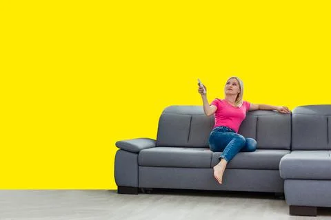Front view full length joyful young mixed race woman relaxing on cozy couch in Stock Photos