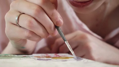Front view of girl drawing at table. Concentrated face of artist. Stock Footage 130127753