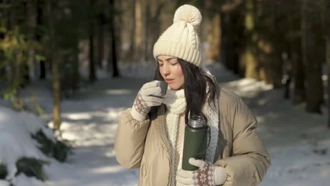Front view. Girl drinks warm tea in the woods in winter. Stock Footage 154205747