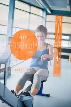 Front view of a girl on rowing machine with futuristic interface showing Stock Illustration