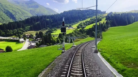 Front View on Glacier Express Train with Railroad Tracks and Mountainscape Stock Footage 287212314