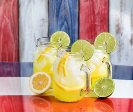 Front view of a glasses filled with cold lemonade.  Faded wooden boards paint Stock Photos