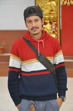 Front view of a good looking Indian young guy wearing cap backwards  Stock Photos
