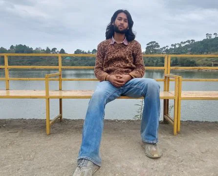 Front view of a good looking Indian young man with long hair and beard Stock Photos