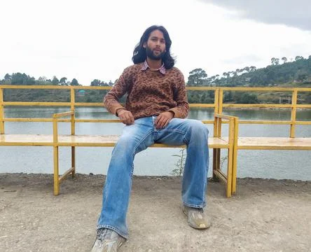 Front view of a good looking Indian young man with long hair and beard Stock Photos