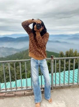 Front view of a good looking long haired young man photographe taking photo  Stock Photos