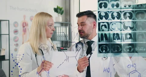 Front view of good-looking positive experienced adult male and female doctors Stock Footage 160347711