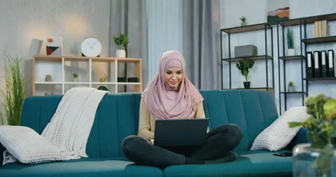Front view of good-looking satisfied joyful young muslim woman in hijab which Stock Footage 150114331