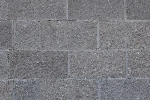 Front view of grey brick wall texture background. Tiled concrete cement surface. Stock Photos