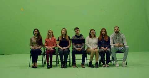 Front view group of young people sitting and looking at something Stock Footage 105834888