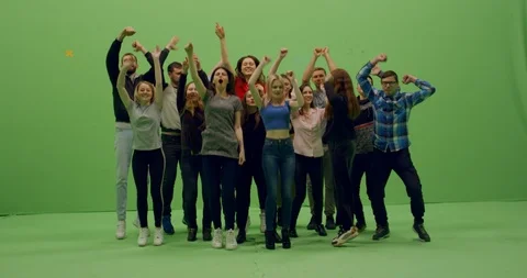 Front view group of young people dancing and jumping with hands in the air Video stock 105842253