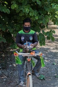 Front view of a guy sharpening tools on his bicycle Stock Photos