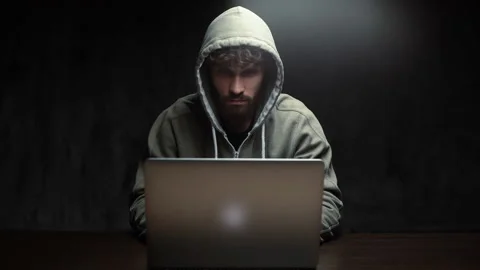 Front view of hacker man hacking online web site or engaging hacking into Video stock 142510580