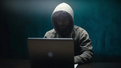 Front view of hacker man hacking online web site or engaging hacking into Video stock 145122830