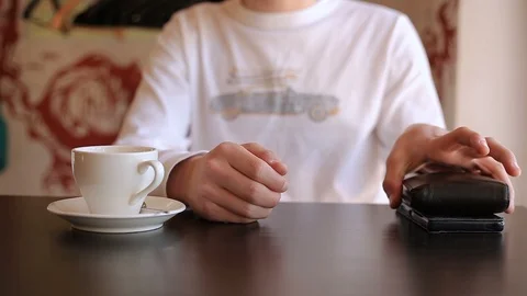 Front view hands of a young man take a wallet, open it and check the availabilit Stock Footage 113671453