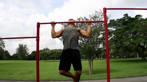Front view. handsome athletic guy pulls on the bar. Pullups Stock Footage 26356061