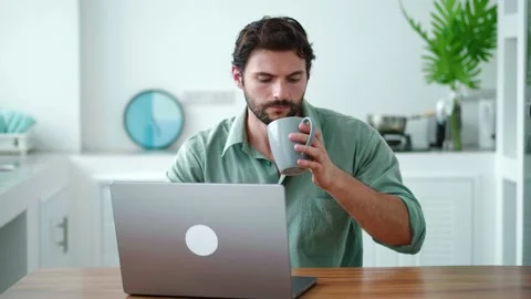 Front view of a handsome young freelancer working with laptop computer remotely Stock Footage 213259047