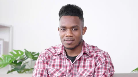 Front view of Happy black man video calling looking at camera communicate Stock Footage 165437813