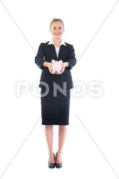 Front view of happy businesswoman holding a piggy bank Stock Photos
