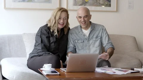 Front view of happy couple looking at home project Stock Footage 121002059