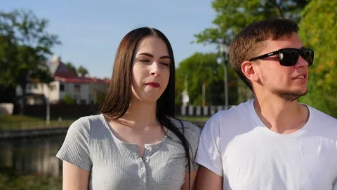 Front view of happy couple walking outdoor, smiling and talking together in park Stock Footage 116664742