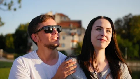 Front view of happy couple walking outdoor, smiling and talking together in park Stock Footage 116704208