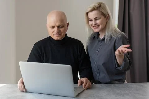 Front view happy elderly 70s grey haired man learning using computer software Stock Photos