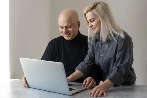 Front view happy elderly 70s grey haired man learning using computer software Stock Photos