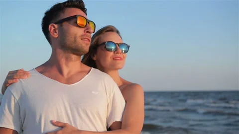 Front View of Happy Smiling Couple in Fashionable Sunglasses Hugging on the Stock Footage 93174997