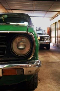 Front view of the headlight of a classic car parked in the garage 스톡 사진
