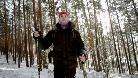 Front view of a Hiker going in the forest at winter Stock Footage 70827782