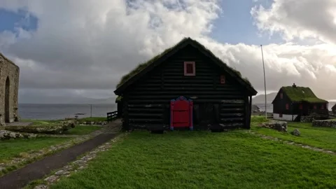 Front view of historic Roykstovan turf-roofed farmhouse in Kirkjubour Stock Footage 339931816