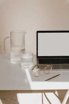 Front view home office workspace. Laptop computer with blank screen, glasses, Stock Photos