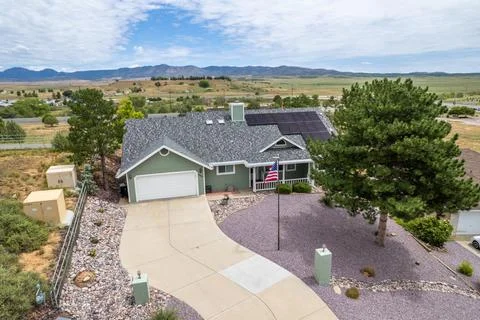 The front view of a home with a yard Stock Photos