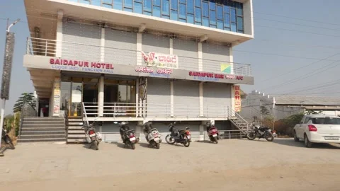 Front view of hotel along the road, Road side view shops Stock Footage 151958261