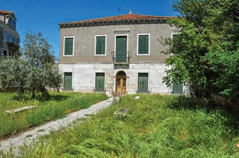 Front view of house with wheat in the front yard in Murano Stock Photos