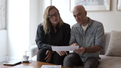 Front view of interior designer and home owner talking about sketches, drafts Stock Footage 121003111