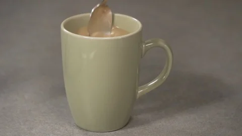 Front view-italian coffee maker pouring sugar in a green coffee cup 4k Stock Footage 96146917