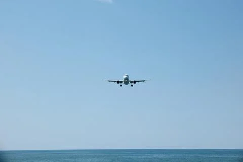 Front View of Jet Passenger Plane Flying Over the Sea Stock Photos