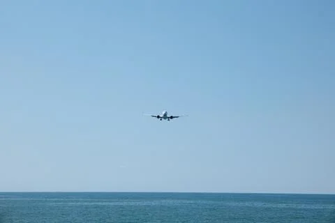 Front View of Jet Passenger Plane Flying Over the Sea Stock Photos